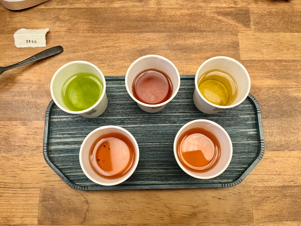 5 cups of tea on a black platter